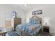 Bedroom showcasing a bed with blue bedding, complemented by a dresser and natural light at 4787 Wild Iris Dr. # 203, Myrtle Beach, SC 29577