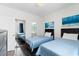Comfortable bedroom with two beds, a sliding door closet, and coastal-themed decor at 4787 Wild Iris Dr. # 203, Myrtle Beach, SC 29577