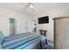 Bedroom featuring a TV, cozy bed, and an attached bathroom, creating a private retreat at 4787 Wild Iris Dr. # 203, Myrtle Beach, SC 29577