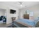 Bright bedroom featuring a ceiling fan, large TV, complemented by large windows for ample natural light at 4787 Wild Iris Dr. # 203, Myrtle Beach, SC 29577