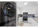 Modern kitchen with stainless steel appliances and sleek white cabinets at 4787 Wild Iris Dr. # 203, Myrtle Beach, SC 29577