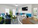 Bright living room with a large window, a wall-mounted TV, and an adjacent bathroom at 4787 Wild Iris Dr. # 203, Myrtle Beach, SC 29577