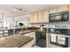 Galley kitchen with sleek countertops, modern appliances, and ample cabinet space at 4800 S Ocean Blvd. # 304, North Myrtle Beach, SC 29582