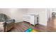 Bedroom featuring a crib, wood-look flooring, and a comfortable reclining armchair at 5026 Adrian Hwy., Conway, SC 29526
