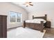 Bright primary bedroom showcasing wood flooring, vaulted ceilings, large window, and a neutral color palette at 5026 Adrian Hwy., Conway, SC 29526
