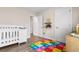 Bright bedroom featuring a crib, colorful alphabet mat, and wood-look flooring at 5026 Adrian Hwy., Conway, SC 29526