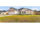 Attractive single-story home with a two-car garage, well-kept lawn, light yellow siding, and a gray roof at 5026 Adrian Hwy., Conway, SC 29526