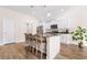Spacious kitchen with white cabinets, island seating, stainless steel appliances, and wood-look floors at 5026 Adrian Hwy., Conway, SC 29526