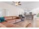 Bright living room featuring a brown leather sofa and a kitchen with white cabinetry and stainless steel appliances at 5026 Adrian Hwy., Conway, SC 29526