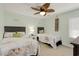 Inviting bedroom with two beds, a ceiling fan, and coastal-themed decor for a relaxing ambiance at 513 Hillside Dr. S, North Myrtle Beach, SC 29582