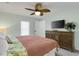 Cozy bedroom with a full size bed, wood-look dresser, and large window for natural light at 513 Hillside Dr. S, North Myrtle Beach, SC 29582