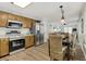 Well-equipped kitchen with stainless appliances and wooden cabinets, flowing into a cozy dining area at 513 Hillside Dr. S, North Myrtle Beach, SC 29582
