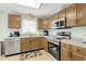 Bright kitchen with stainless steel appliances, wooden cabinetry, and plenty of counter space at 513 Hillside Dr. S, North Myrtle Beach, SC 29582