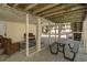 View of a shaded outdoor space with string lights, picnic table, and wicker seating at 513 Hillside Dr. S, North Myrtle Beach, SC 29582