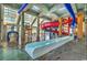 Indoor waterpark with winding slides, colorful play areas, and clear views of the outdoor buildings at 5200 Ocean Blvd. N # 855, Myrtle Beach, SC 29577