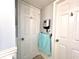 Hallway featuring 2 white paneled doors, towel rack and paneled lower walls at 5523 North Ocean Blvd. # 2112, Myrtle Beach, SC 29577