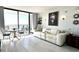 Comfortable living room with ocean views from the balcony, complemented by a white sofa and elegant decor at 5523 North Ocean Blvd. # 2112, Myrtle Beach, SC 29577