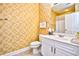 Cozy bathroom with toilet, sink, and decorative yellow and brown textured walls and a patterned floor at 5650 Barefoot Resort Bridge Rd. # 234, North Myrtle Beach, SC 29582