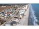 Extensive aerial view of beachfront properties, showcasing a vibrant coastal community along the shoreline at 627 North Waccamaw Dr. # 212, Murrells Inlet, SC 29576