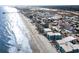 Expansive aerial view showcasing a coastal town with beachfront homes and condos alongside the beautiful shoreline at 627 North Waccamaw Dr. # 212, Murrells Inlet, SC 29576