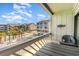 Cozy balcony view showcases nearby palm trees, residential architecture, and a glimpse of community pool at 627 North Waccamaw Dr. # 212, Murrells Inlet, SC 29576