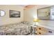A quaint bedroom featuring a bed with an antique-style quilt, a small bedside table, and a dresser at 627 North Waccamaw Dr. # 212, Murrells Inlet, SC 29576