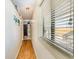 Hallway with wood flooring, a window with blinds and decor at 627 North Waccamaw Dr. # 212, Murrells Inlet, SC 29576