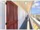 Exterior condo hallway featuring weathered door, white paint, and glimpses of the community at 627 North Waccamaw Dr. # 212, Murrells Inlet, SC 29576
