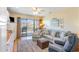 Comfortable living room with a sofa, rug, and sliding door access to the balcony at 627 North Waccamaw Dr. # 212, Murrells Inlet, SC 29576