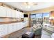 Bright living space with a kitchen, cozy seating, and balcony access offering outdoor views at 627 North Waccamaw Dr. # 212, Murrells Inlet, SC 29576