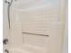Close-up of a shower stall featuring a textured surround and chrome hardware at 627 North Waccamaw Dr. # 212, Murrells Inlet, SC 29576