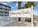 Welcome to Whispering Sands: An inviting sign near a community pool area amidst tropical palm trees at 627 North Waccamaw Dr. # 212, Murrells Inlet, SC 29576