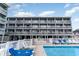 Inviting community pool with lounge chairs and clear water for relaxation and recreation in a resort environment at 627 North Waccamaw Dr. # 212, Murrells Inlet, SC 29576