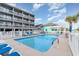 Community pool and deck with lounge chairs, offering a serene spot for relaxation and recreation at 627 North Waccamaw Dr. # 212, Murrells Inlet, SC 29576