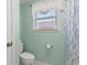Bright bathroom with neutral walls, toilet, and a window with stylish blinds for natural light at 633 White Oak Ln., North Myrtle Beach, SC 29582