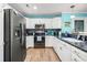 Well-lit kitchen with stainless steel appliances, granite countertops, tile backsplash, and a stylish sink area at 633 White Oak Ln., North Myrtle Beach, SC 29582