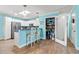 Bright kitchen featuring white cabinets, a pantry, stainless steel appliances, and an island with bar seating at 633 White Oak Ln., North Myrtle Beach, SC 29582
