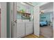 Laundry room features a side-by-side washer and dryer, and shelf space for storage at 633 White Oak Ln., North Myrtle Beach, SC 29582