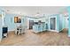 Open-concept living area featuring wood-look floors, stylish lighting, and a breakfast bar with white cabinetry at 633 White Oak Ln., North Myrtle Beach, SC 29582