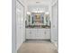 En-suite bathroom with dual sinks, granite countertops, and white cabinets for ample storage at 633 White Oak Ln., North Myrtle Beach, SC 29582