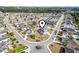 Beautiful aerial view of a neighborhood with homes surrounding a tranquil lake at 654 Evers Loop, Surfside Beach, SC 29575