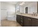 Bathroom features a soaking tub, double sink vanity, and tiled floors at 654 Evers Loop, Surfside Beach, SC 29575