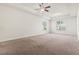 This carpeted bedroom features a ceiling fan and tray ceilings at 654 Evers Loop, Surfside Beach, SC 29575