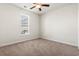 This bedroom features neutral walls, a window, and a ceiling fan at 654 Evers Loop, Surfside Beach, SC 29575