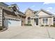 Close-up of a brick home featuring an attached garage and detailed front entrance at 654 Evers Loop, Surfside Beach, SC 29575