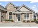 Brick home featuring a covered porch, decorative columns, and manicured shrubs at 654 Evers Loop, Surfside Beach, SC 29575