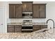 Modern kitchen with granite countertops, stainless steel appliances and tile backsplash at 654 Evers Loop, Surfside Beach, SC 29575