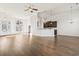 Open concept living area featuring hardwood floors and a partial view of kitchen at 654 Evers Loop, Surfside Beach, SC 29575