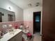 Retro bathroom featuring a pink tile, matching fixtures, and ample lighting at 657 Mulberry Rd., Salters, SC 29590