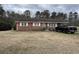 Charming brick home featuring a covered parking area and a spacious front yard at 657 Mulberry Rd., Salters, SC 29590